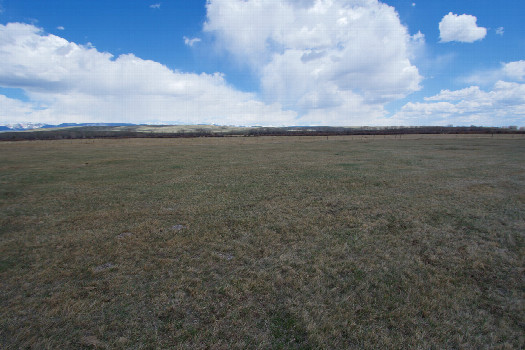#1: The confluence point lies in flat ranchland.  (This is also a view to the East, towards the Wind River Range)