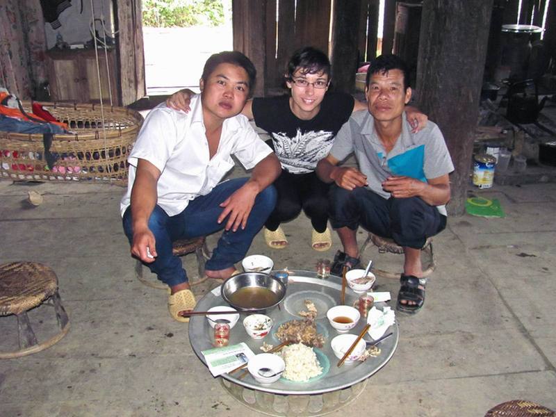 Natie with 2 of the local villagers the next morning after a breakfast of rice, chicken and homemade alcohol.