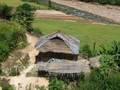 #4: Typical house on the way to the confluence with sustenance of dried river fish and rice fields. 